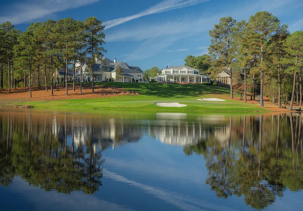 looking across water at clubhouse with hog hole in front