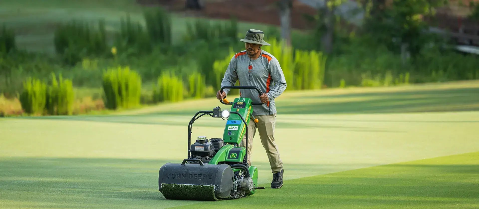 man mowing golf course