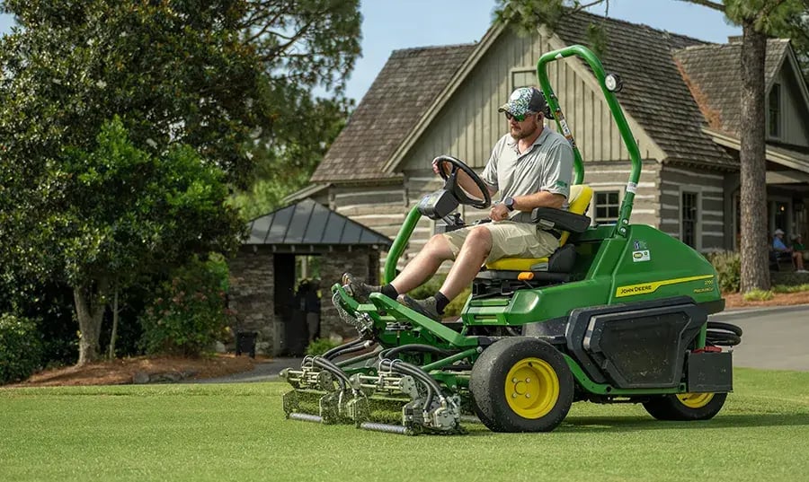 man mowing with zero turn mower