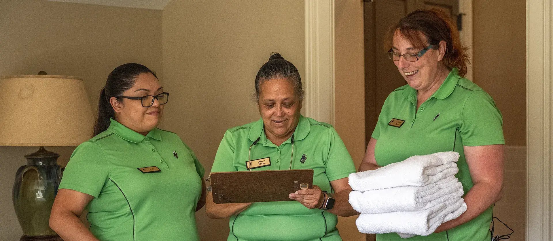 three women checking off list of housekeeping duties