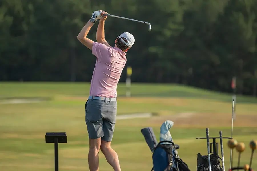 young male golfer at practice range