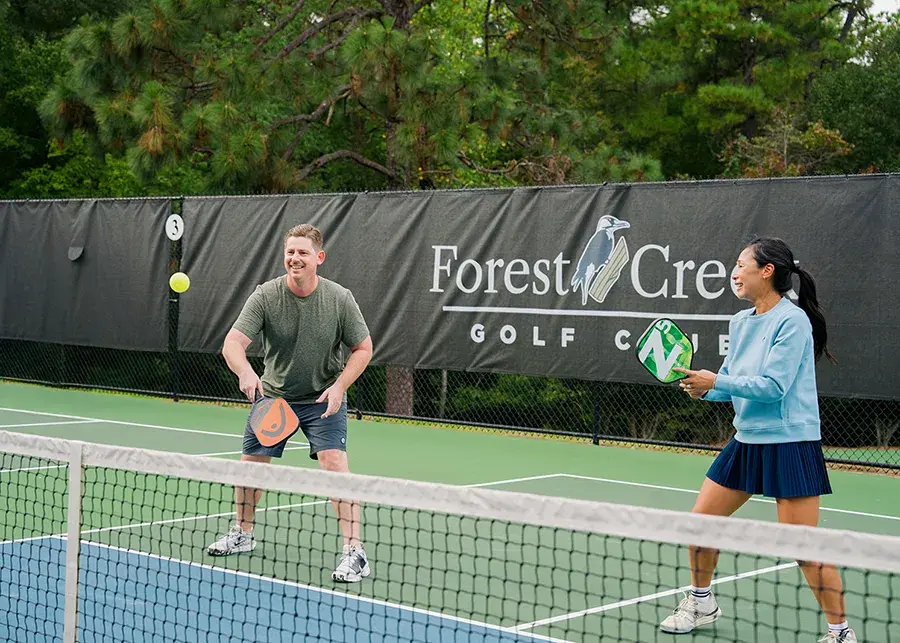 couple playing pickleball at forest creek golf club