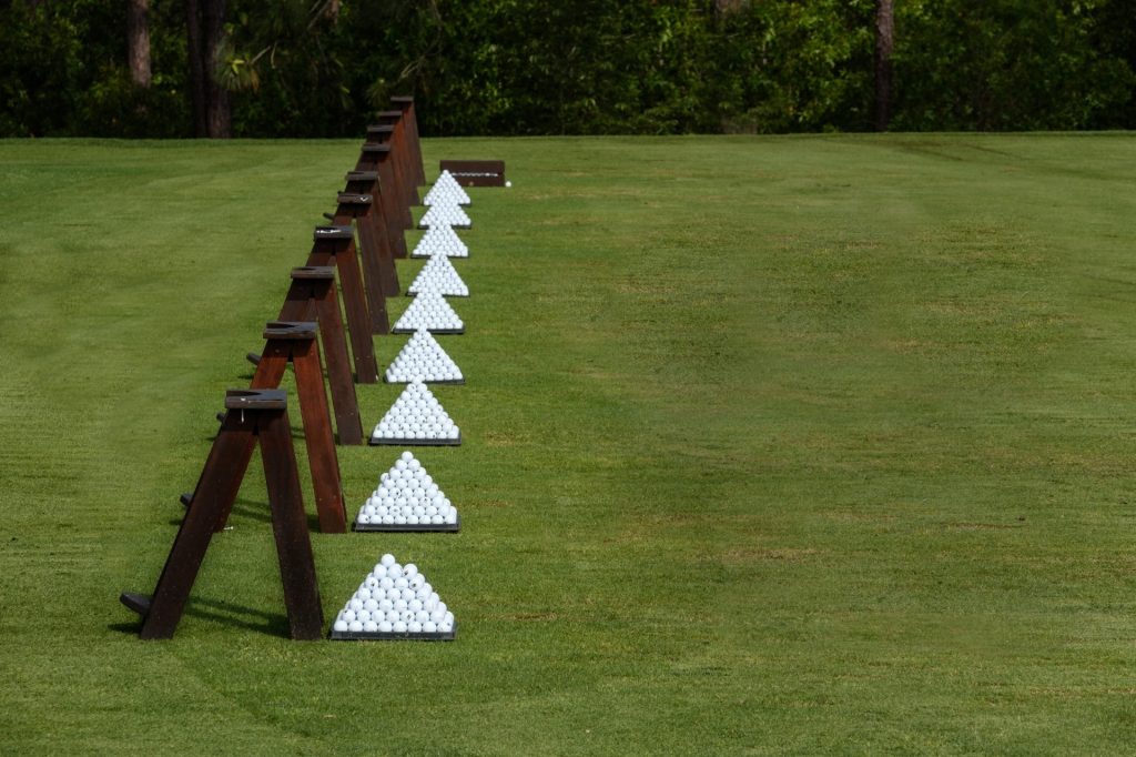 Neatly stacked pyramids of golf balls lined up on the Forest Creek Golf Club driving range in Pinehurst, NC.